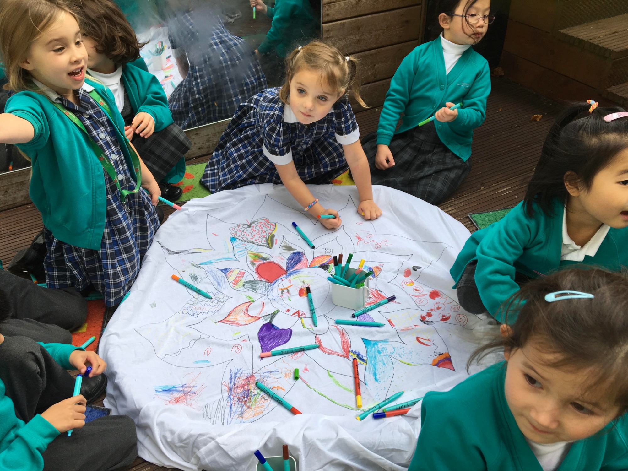 Pre-Prep pupils draw on a rangoli design